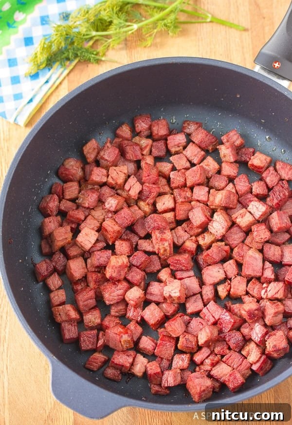 Freshly cubed corned beef, ready to be transformed into a savory hash.