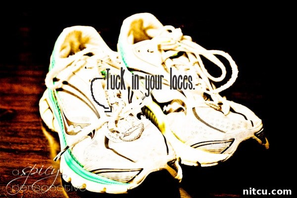 A runner's shoe with laces neatly tucked in to prevent tripping or discomfort.