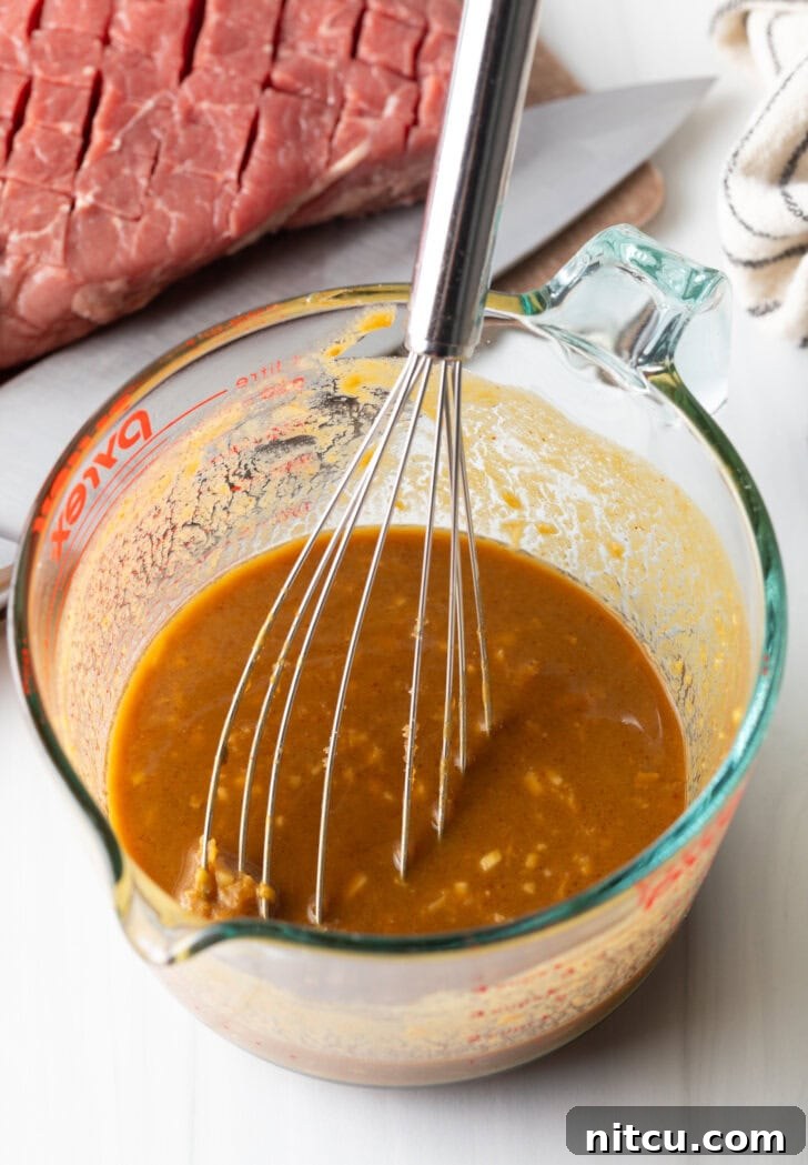 Whisk in a glass measuring cup with marinade.
