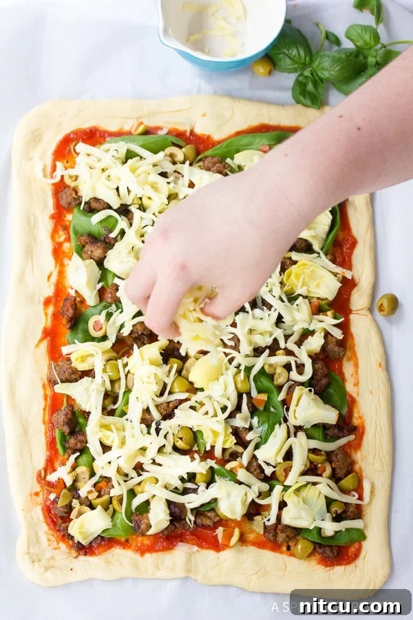 Step-by-step image illustrating the process of filling and rolling a homemade Stromboli on parchment paper.