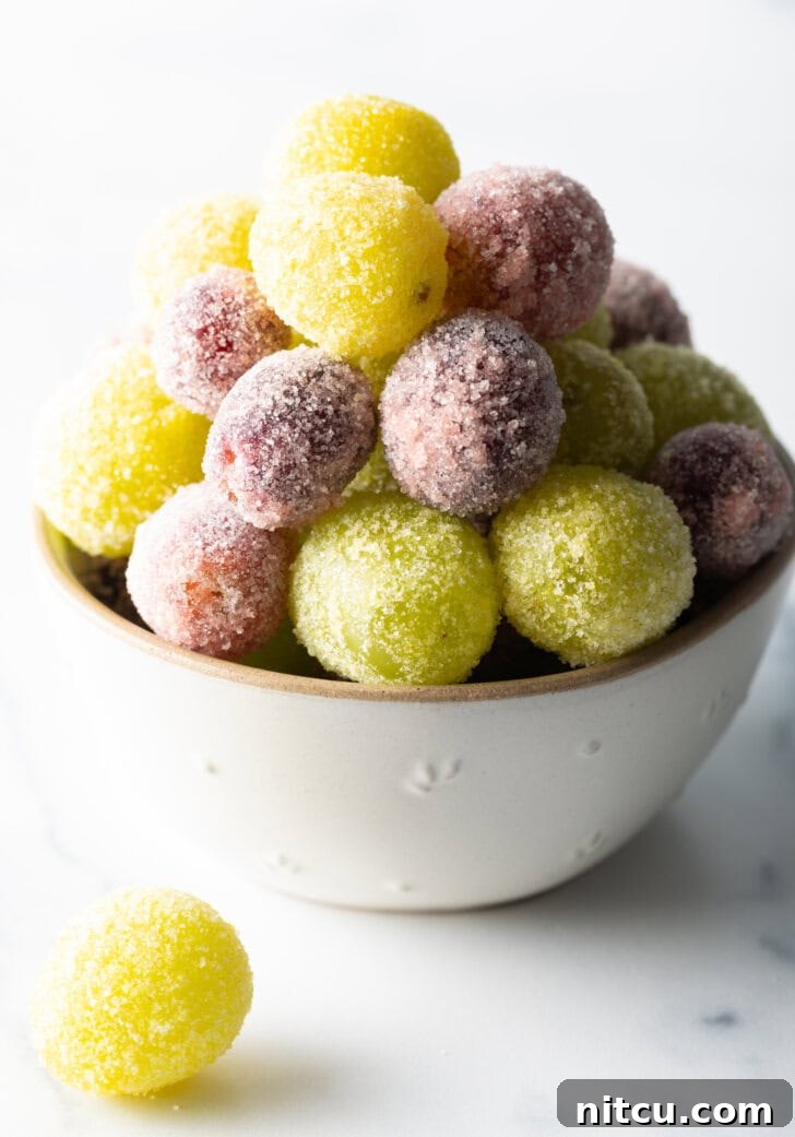 A bowl of green and purple candy grapes.