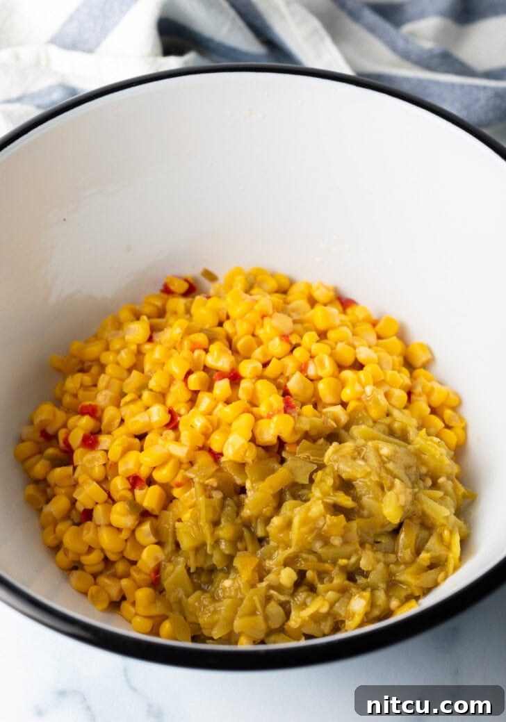 Close-up of a white bowl filled with Mexicorn and finely chopped pickled jalapeño peppers, showcasing the key ingredients.
