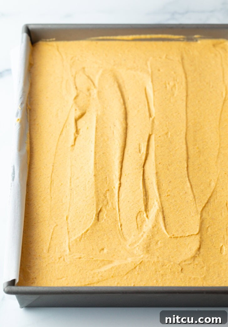 Smooth pumpkin cheesecake in a rectangle baking dish.