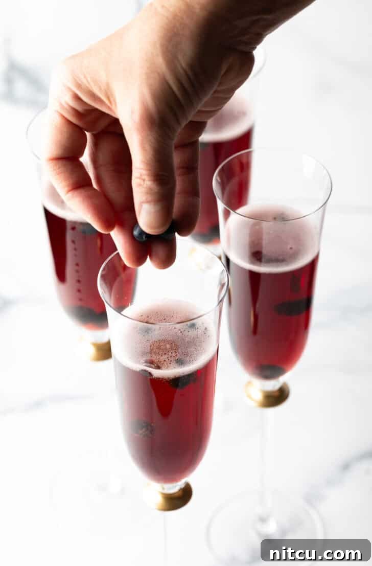 A perfectly prepared Kir Royale cocktail shimmering in a champagne flute.