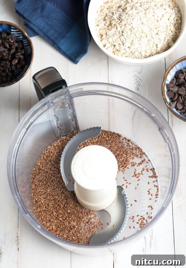 Processing flax seeds in a food processor, a crucial first step for optimal nutrient release.