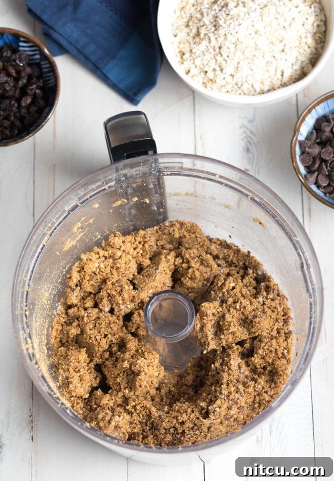 Crumbled energy ball dough in a food processor, showing the ideal consistency before mixing in final additions.