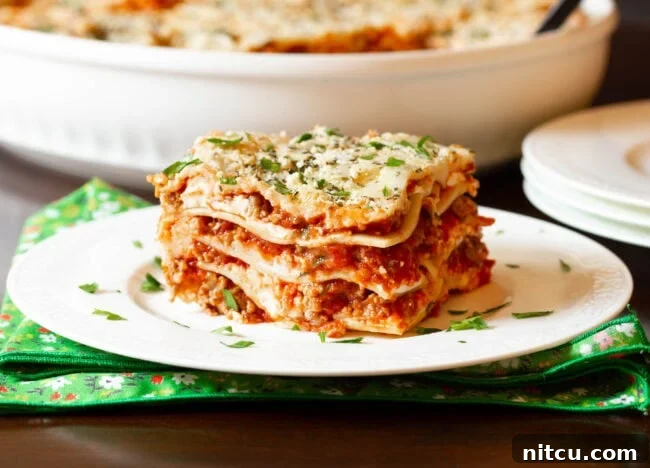 Easy sausage lasagna recipe with cream cheese, beautifully cut into squares on a white plate, ready to be served