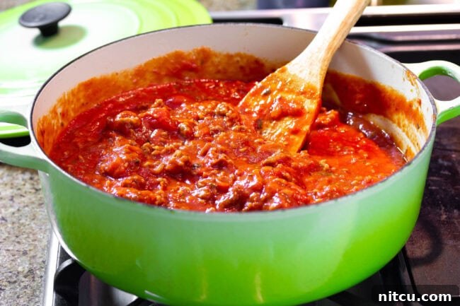 Close-up of rich Italian sausage and tomato sauce, simmering to perfection, a key component for cream cheese lasagna.