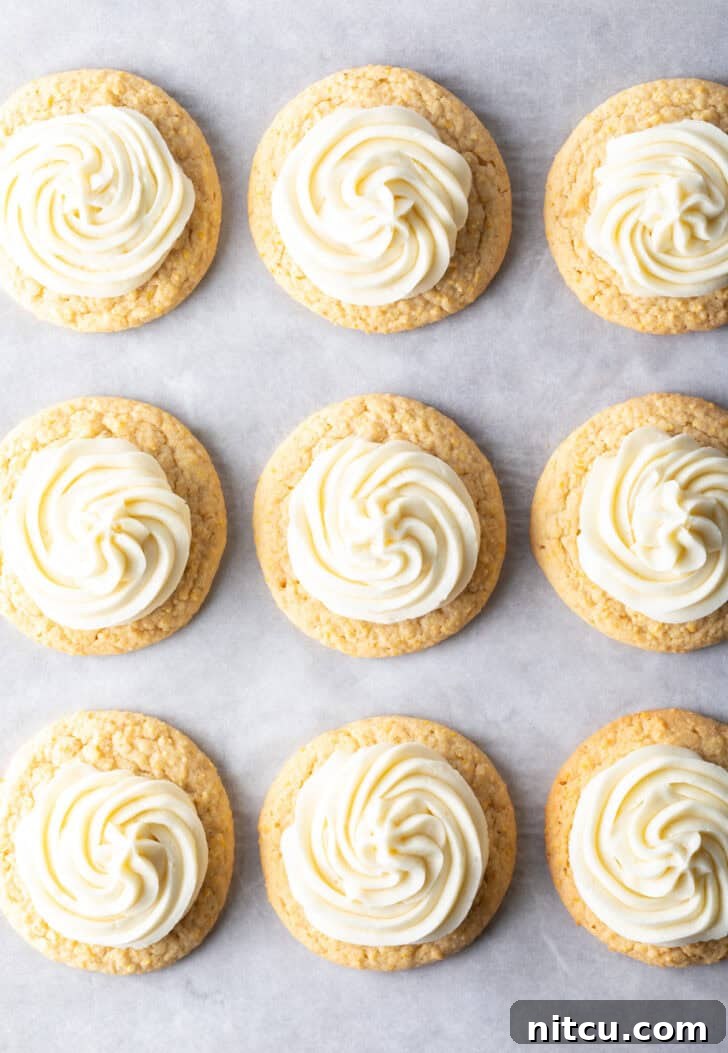 Top down view 9 frosted honey butter cookies on a baking sheet.