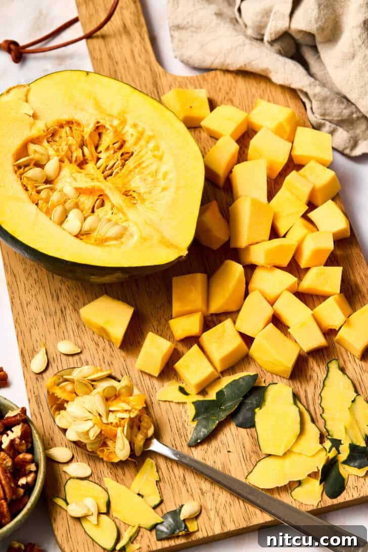 Uncooked butternut squash and other fresh ingredients arranged for the recipe.