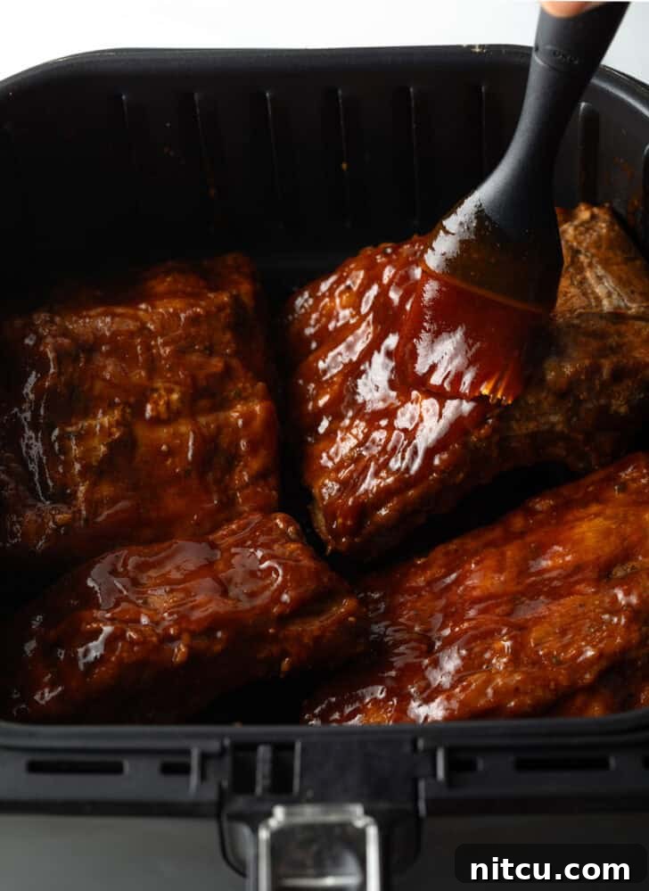 Basting ribs in the air fryer with barbecue sauce