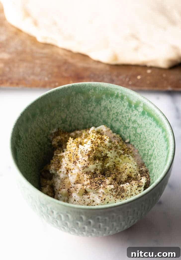 White sauce ingredients in a green bowl, ready to be mixed.