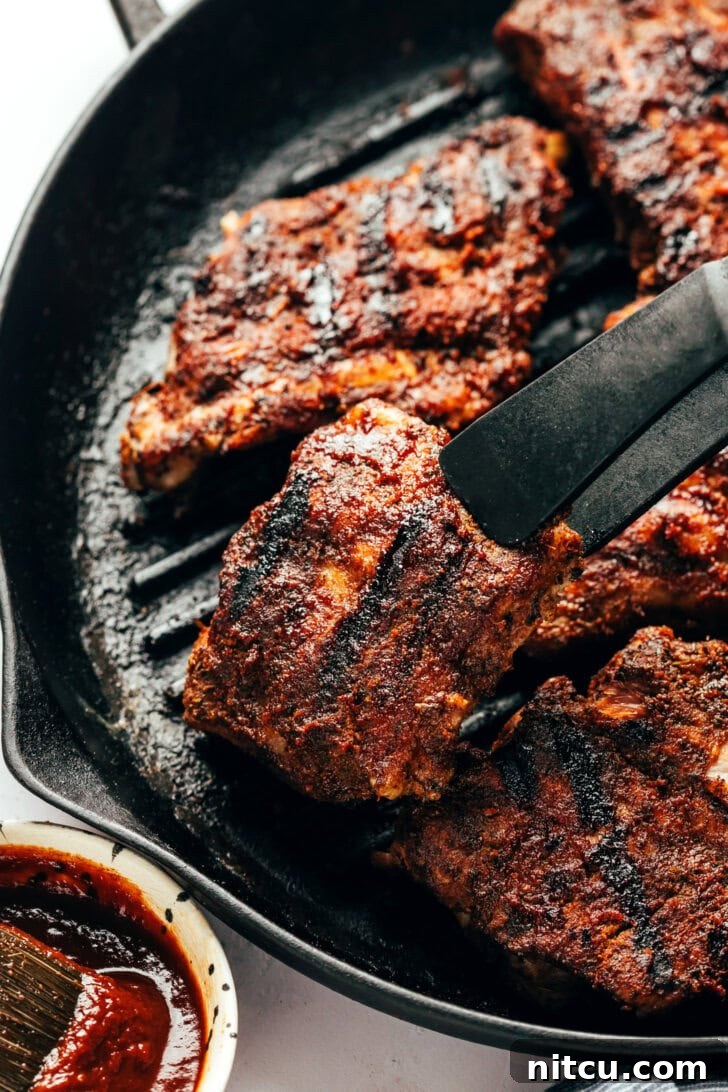 Beautifully grilled baby back ribs, golden brown and saucy