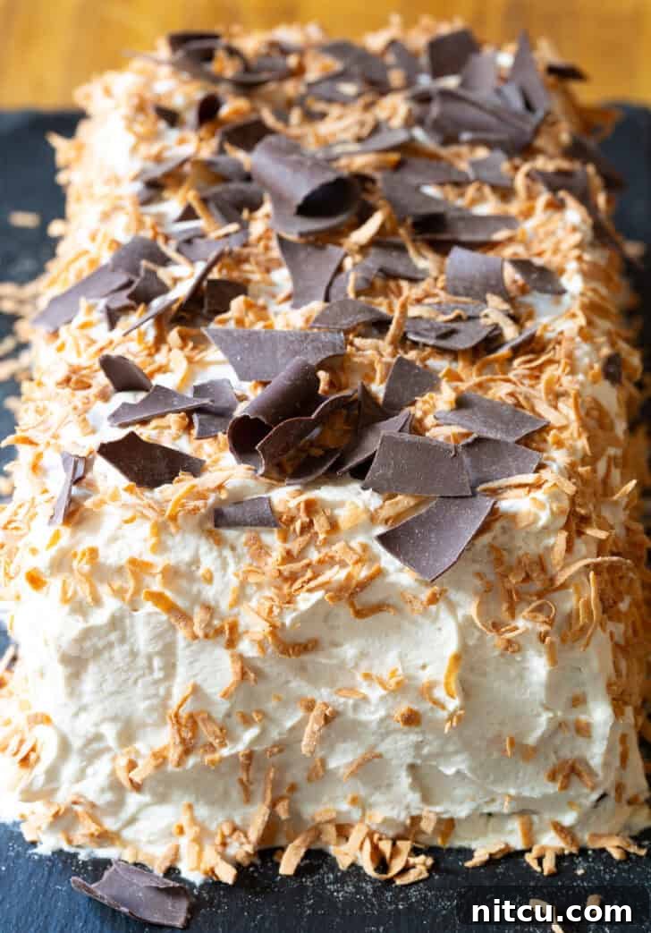 Ice box cake topped with toasted coconut and chocolate shavings.