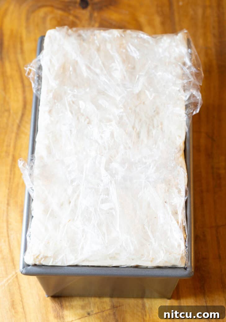 Frozen cake layered in a rectangle baking pan.