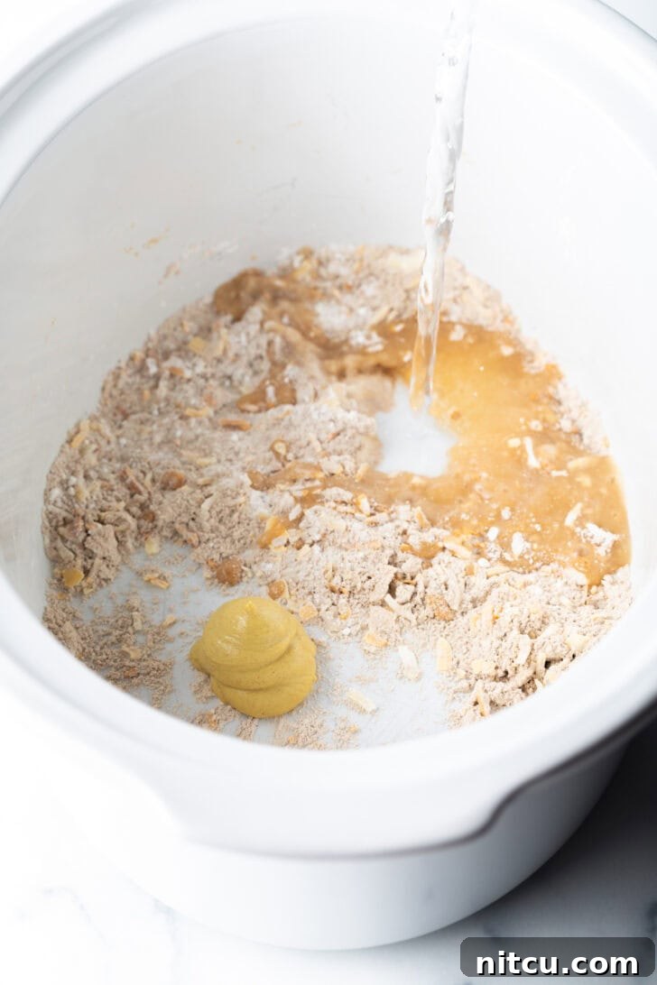 A simple white slow cooker ready for ingredients, representing the start of the cooking process.
