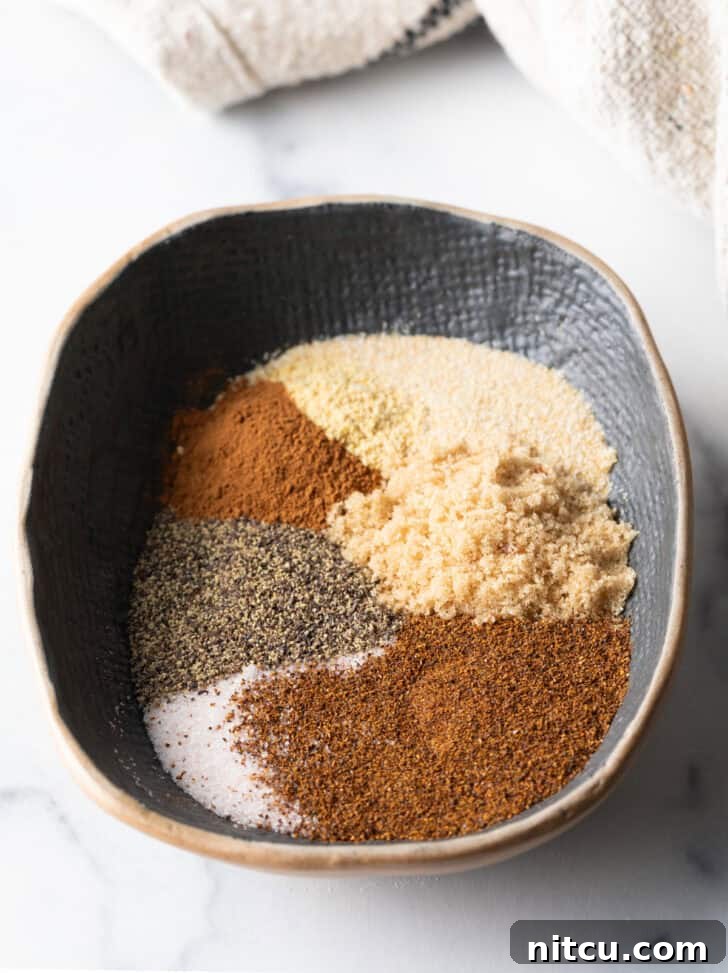 Oval bowl with different spices separated into piles before mixing.