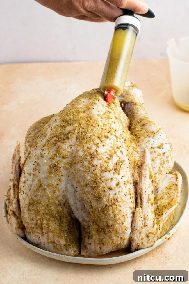 Injecting a raw turkey with a marinade.