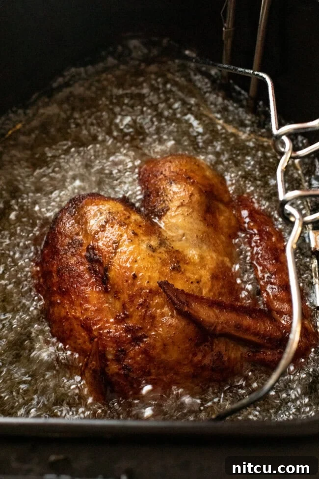 Deep frying a turkey in a deep fryer.