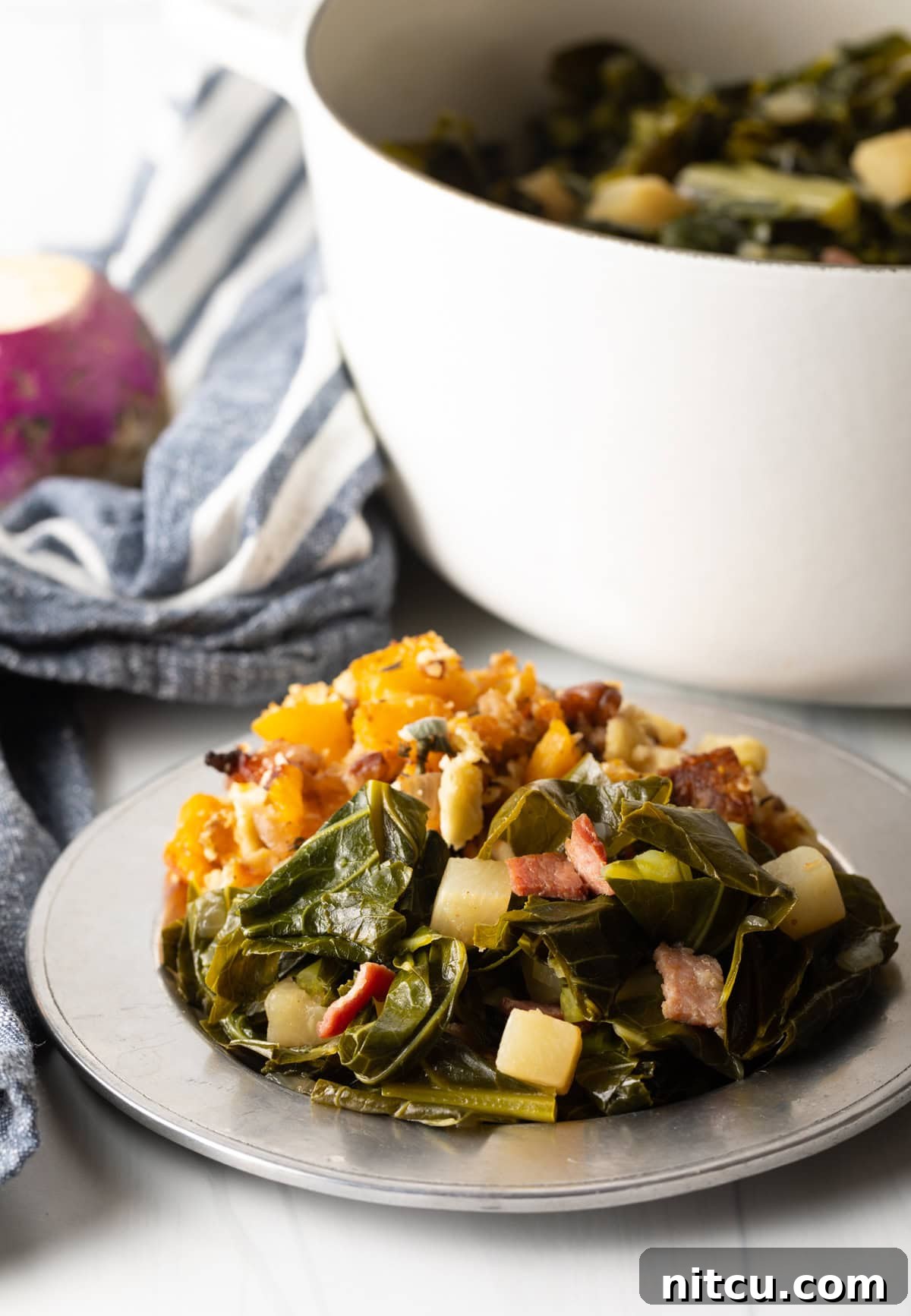 A serving of Southern stewed greens presented on a plate, alongside other delicious Southern dishes for a complete meal.