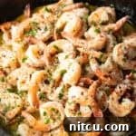 Shrimp in a skillet with herbs and garlic, the main image for the recipe.
