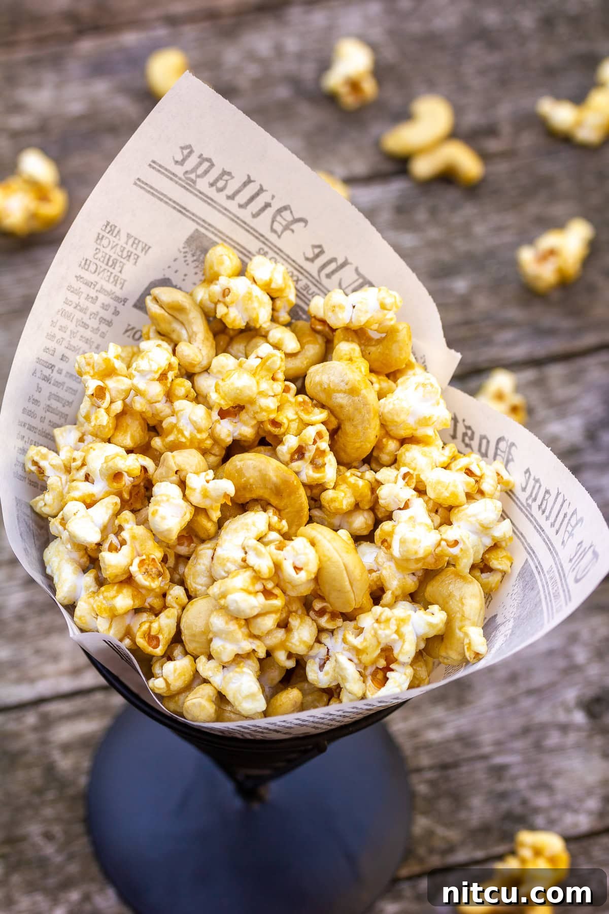 Microwave caramel popcorn recipe shown in a charming paper cone, ready for a delightful snack.