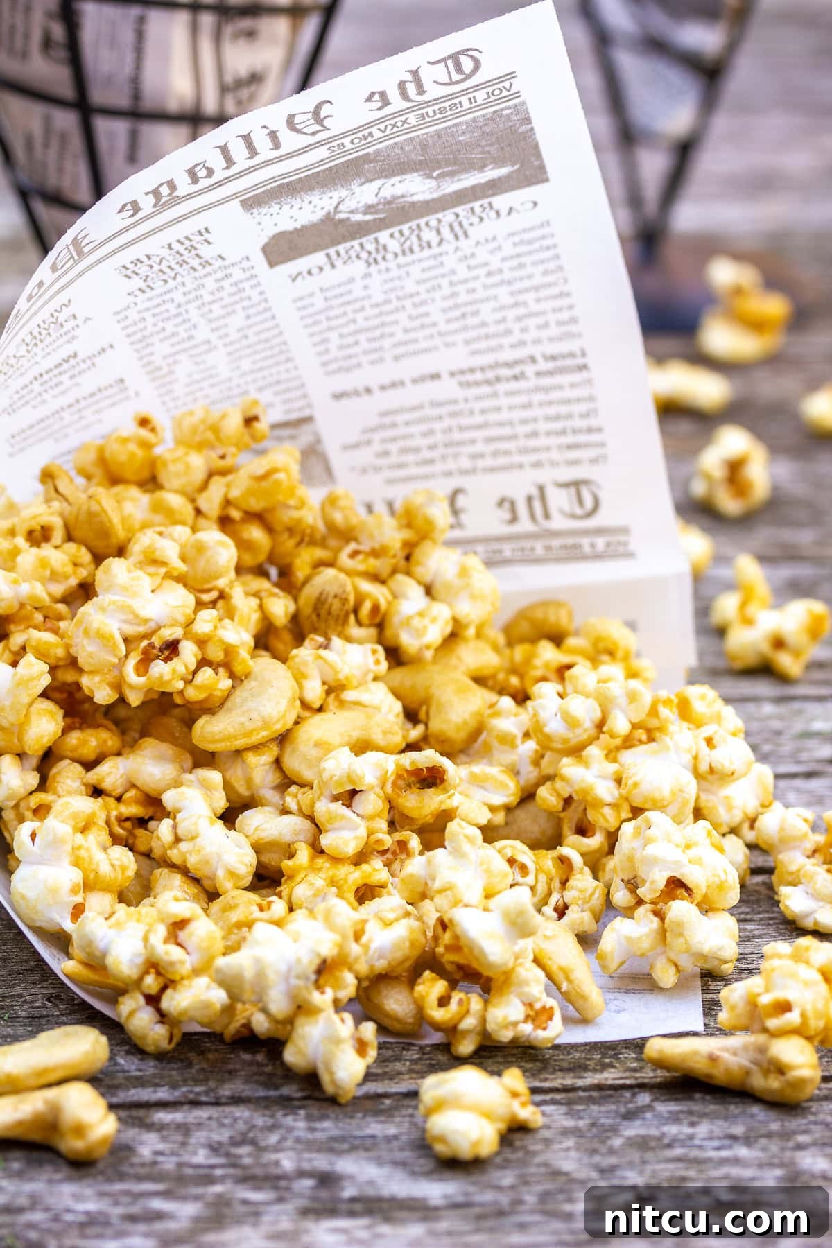 A close-up of microwave caramel corn studded with crunchy cashews, highlighting the perfect, glossy caramel coating.
