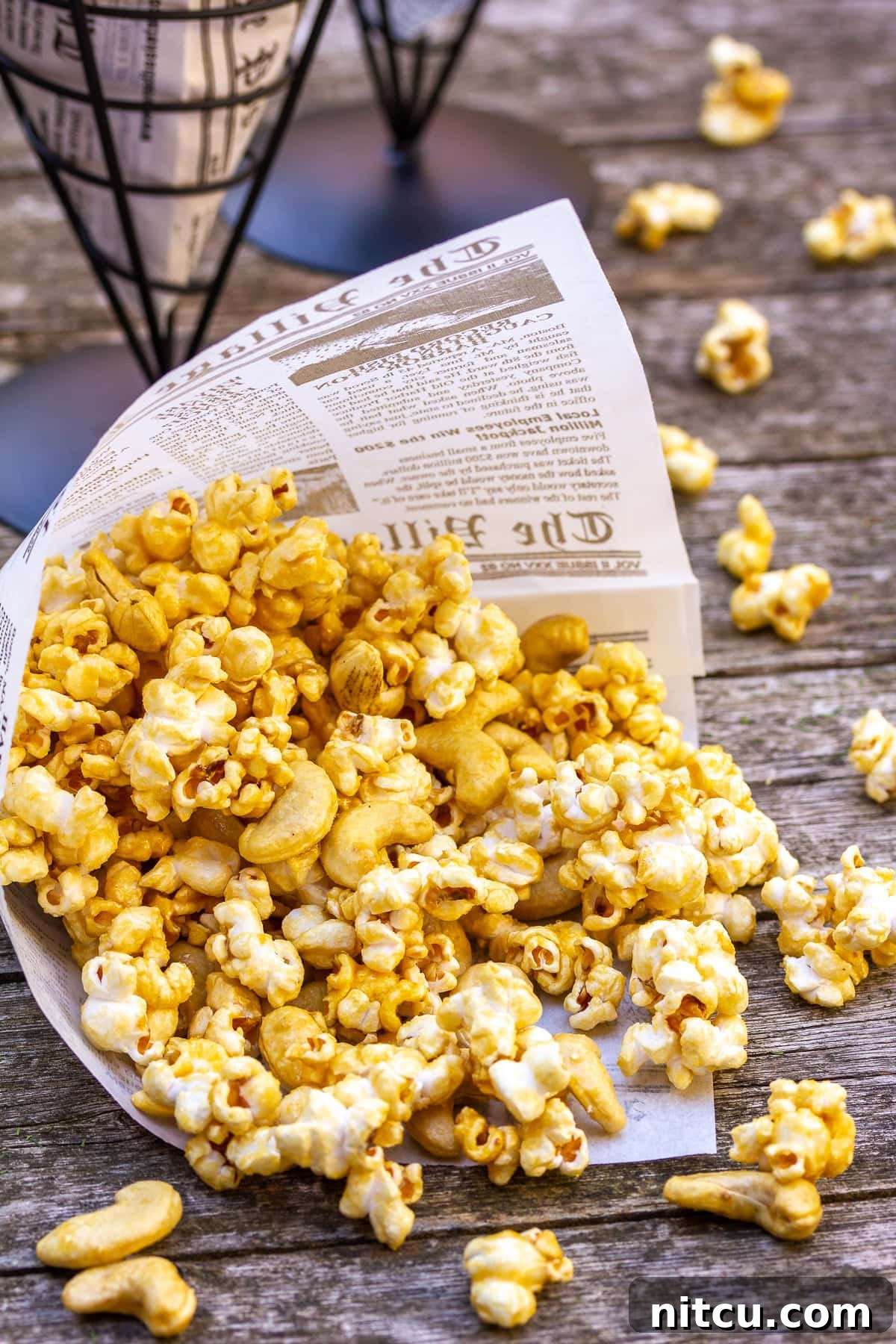 A charming close-up shot of homemade caramel popcorn in a paper cone, highlighting its delicious texture and perfect caramel coating.