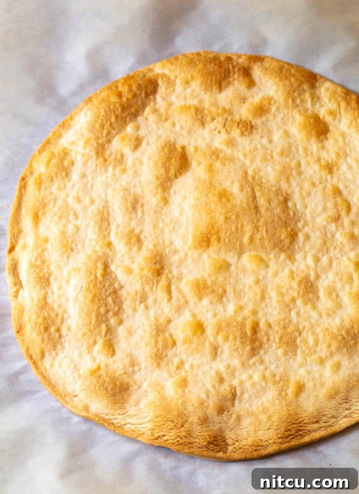Large circular piece of baked golden pie crust.