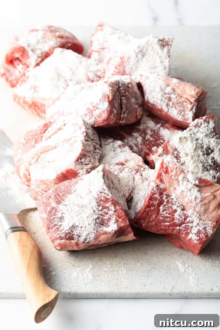 Large chunks of raw beef coated in flour.