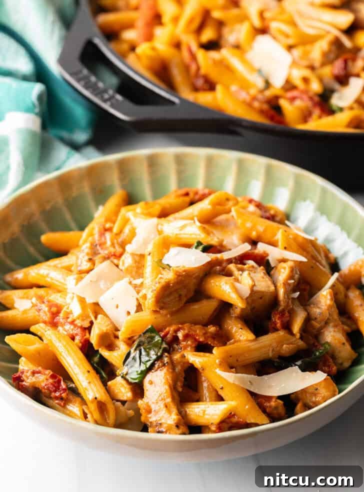 A vibrant green bowl filled with spicy Marry Me Chicken Pasta, ready to be enjoyed.
