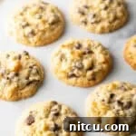 Baked potato chip cookies on white surface.