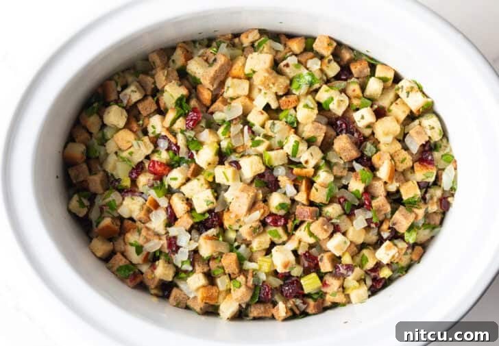 Crock pot dressing fully assembled and ready to be cooked in the slow cooker.