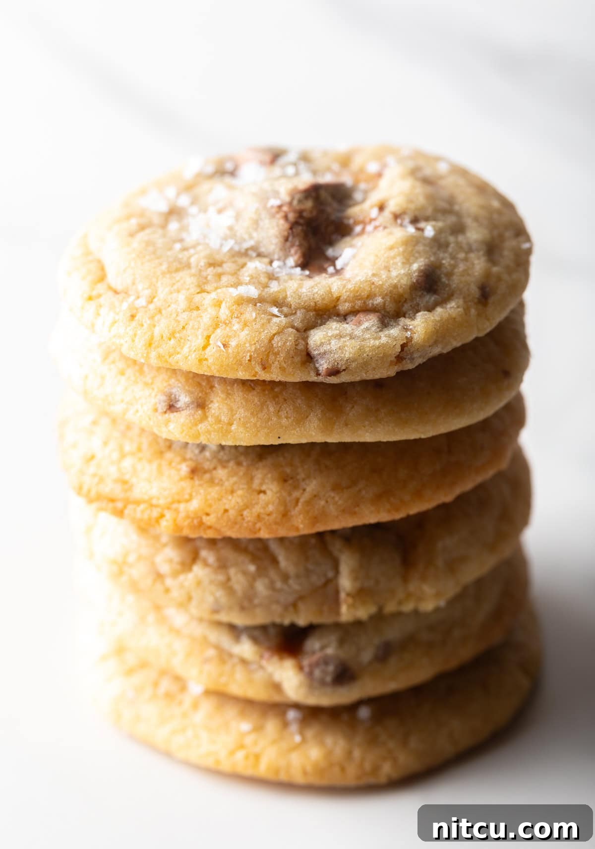 A vertical stack of delicious candy bar cookies, showing off their generous size and tempting texture.