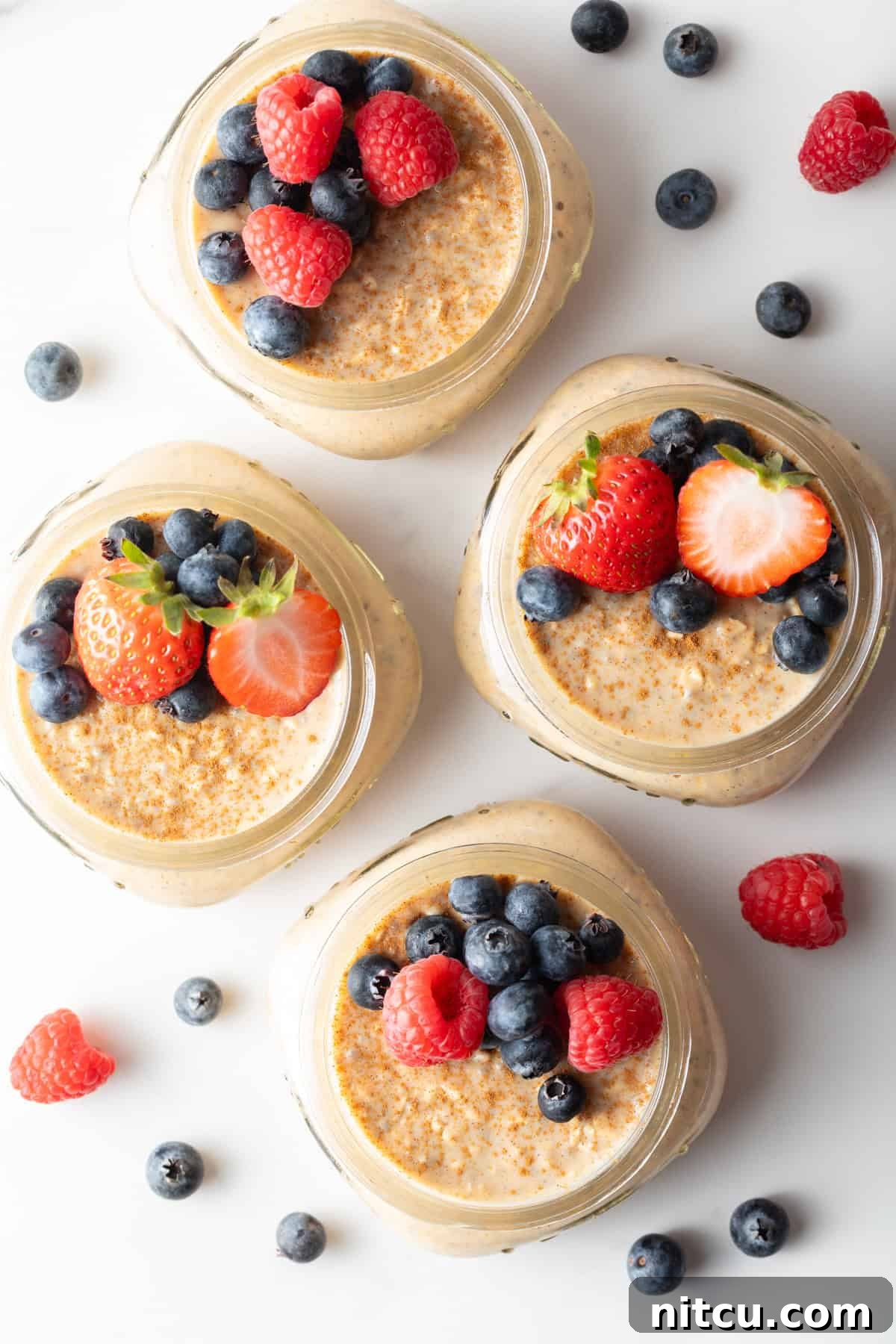 Overhead shot of high protein overnight oats with protein powder and fresh berries