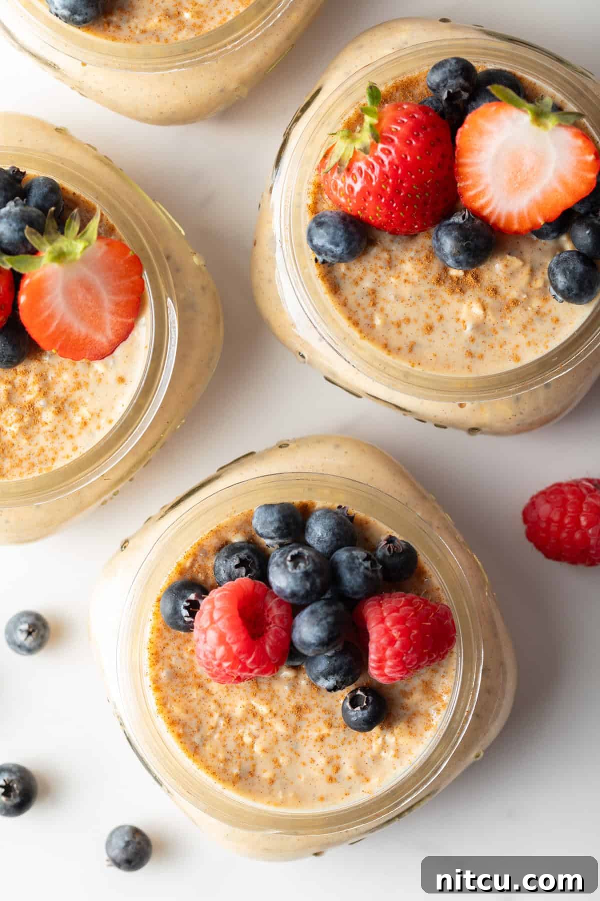 easy overnight oatmeal in small jars with berries