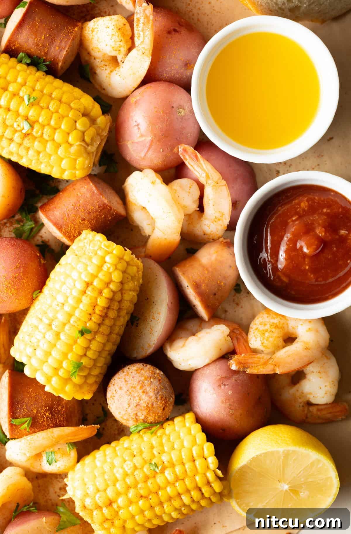 A beautifully presented Low Country Boil, with the vibrant colors of shrimp, corn, potatoes, and sausage spilling abundantly onto a serving surface, ready for a gathering.