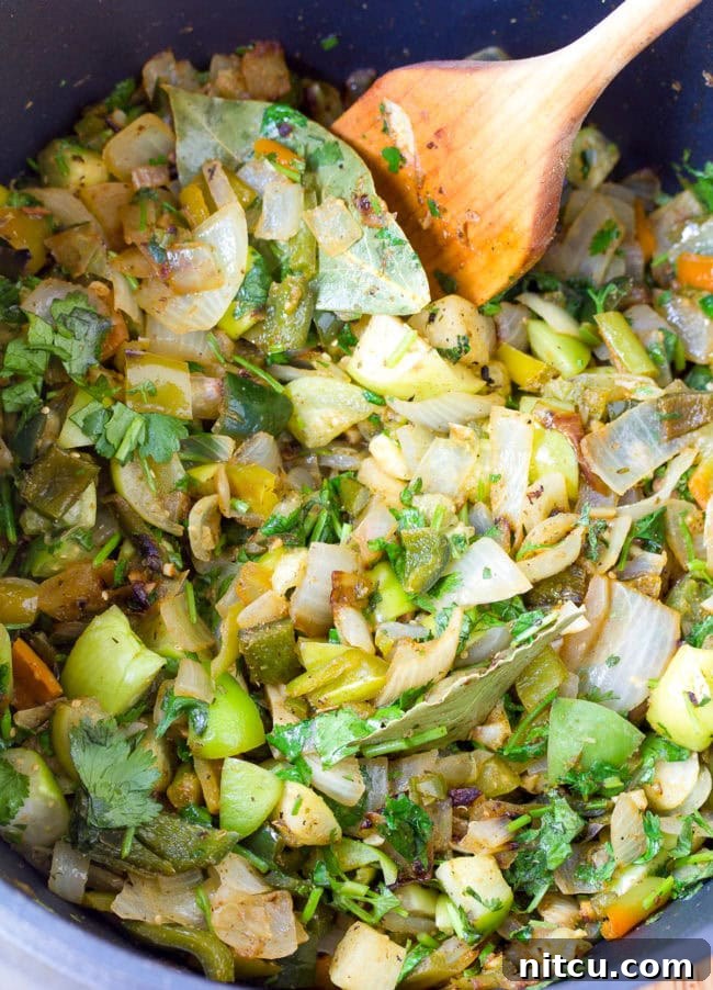 A close-up shot of chopped green chilies and other aromatic vegetables, essential for New Mexico Chile Verde.