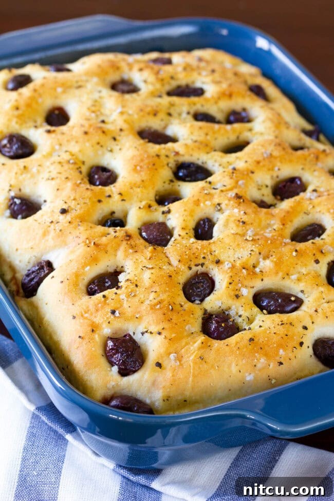 Blue baking dish with tender olive and garlic focaccia bread.