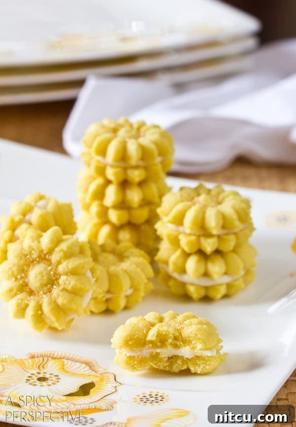 Lemon Spritz Cookie Recipe - made with a cookie press gun and sandwiched together with lemon filling