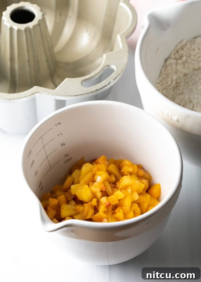 A bowl of fresh, ripe peaches, perfectly diced for the cake recipe.