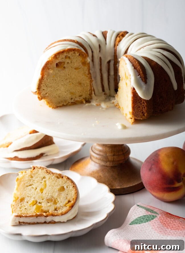 Individual slices of peach bundt cake served on white plates, garnished slightly.