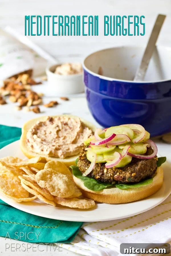 A perfectly cooked Mediterranean burger, garnished with fresh herbs and served on a toasted bun with a side of crispy chips.