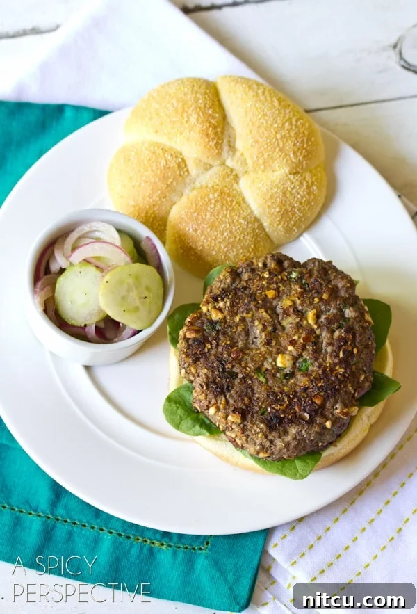 A single Mediterranean burger resting on a plate, showcasing its layers and delicious appearance.