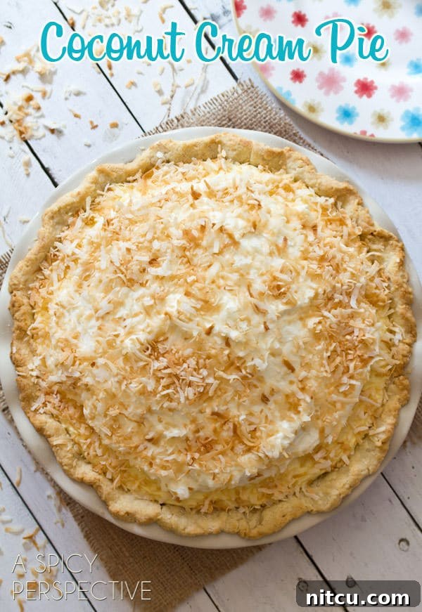 Coconut Cream Pie - A Coconut Pie Recipe with Cream of Coconut - overhead shot of whole pie on white wooden table