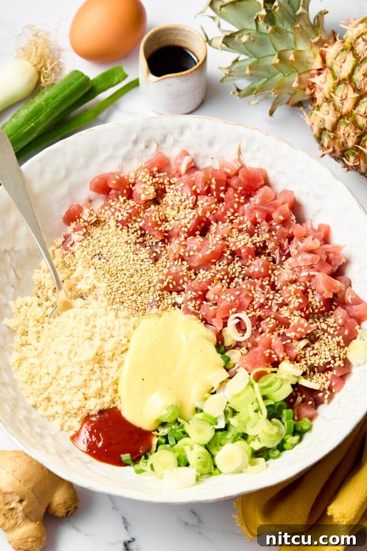 Easy Ahi Tuna Burgers with Grilled Pineapple Recipe - ingredients being mixed in a large bowl to form patties