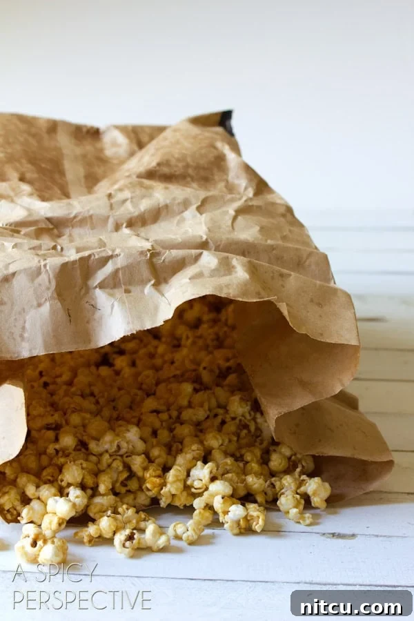 Paper bag filled with caramel popcorn.