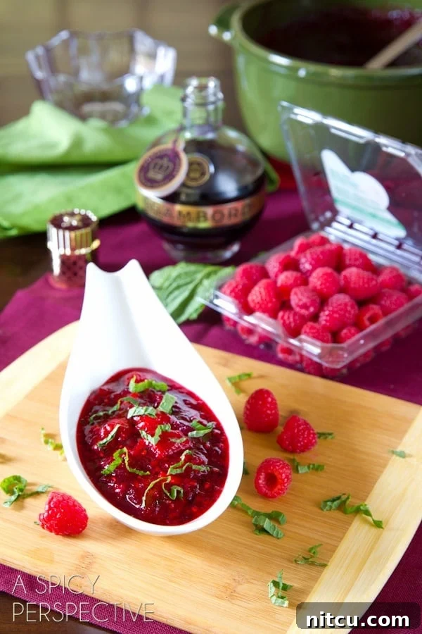 homemade cranberry sauce recipe with raspberries - shown in a small gravy boat