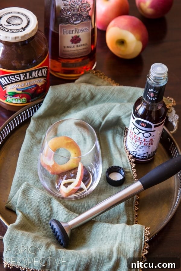 Ingredients needed to make an apple cinnamon old fashioned.
