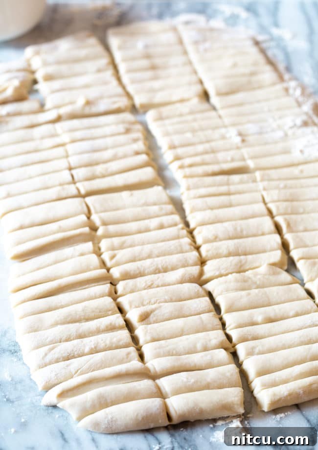 Dumpling dough laid out and sliced into pieces. 